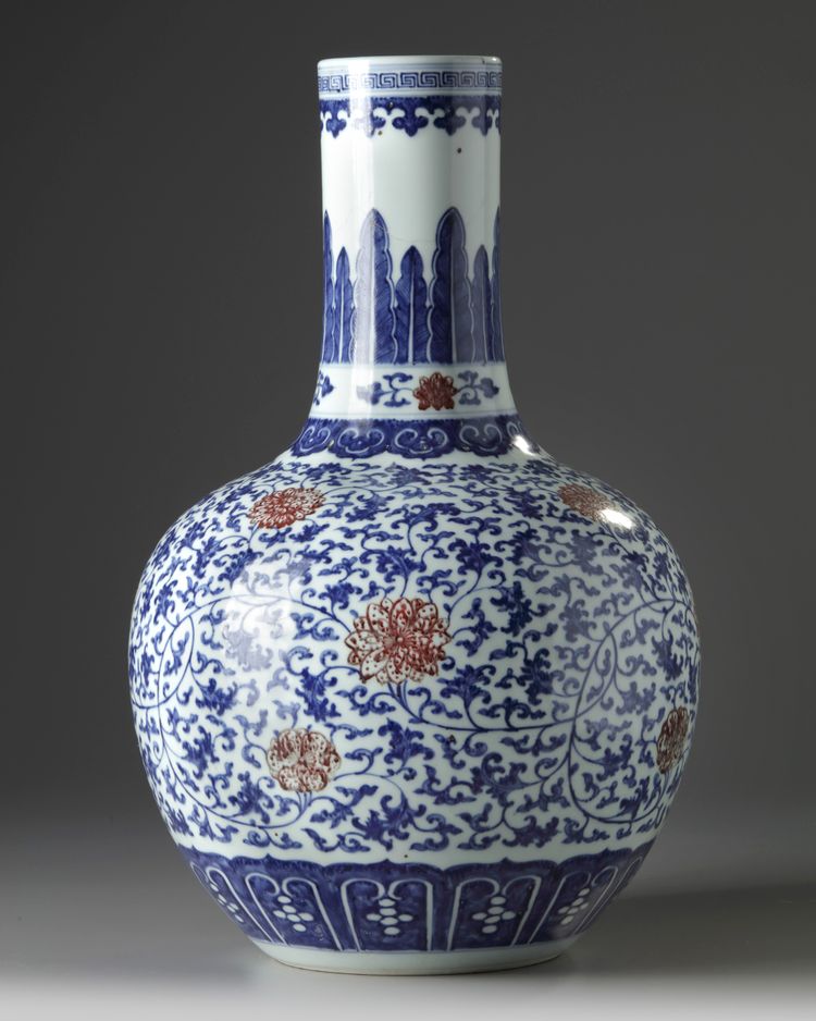 A Chinese blue and white and underglaze copper red-decorated ‘flower scroll’ bottle vase
