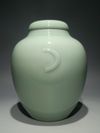 A PAIR OF CHINESE CELADON-GLAZED JARS AND COVERS