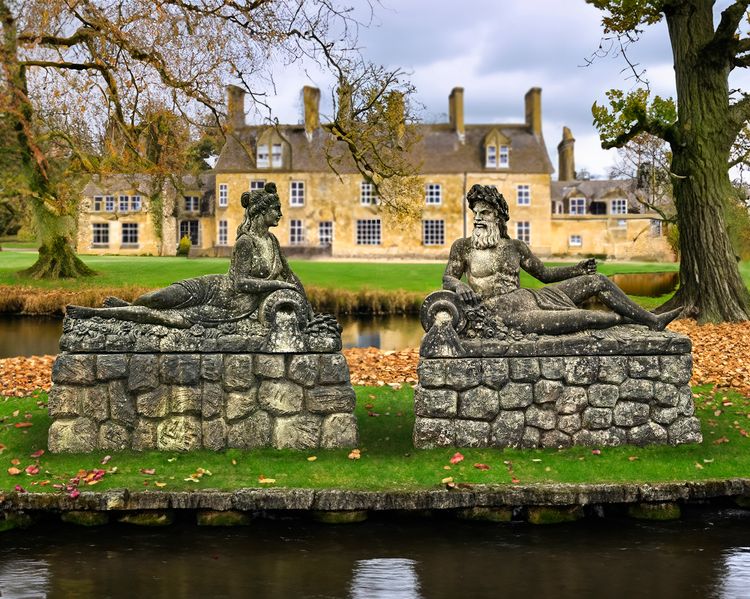 A CARVED LIMESTONE STATUE OF AMPHITRITE (GODDESS OF THE SEA)  AND POSEIDON (NEPTUNE), LATE 19TH CENTURY