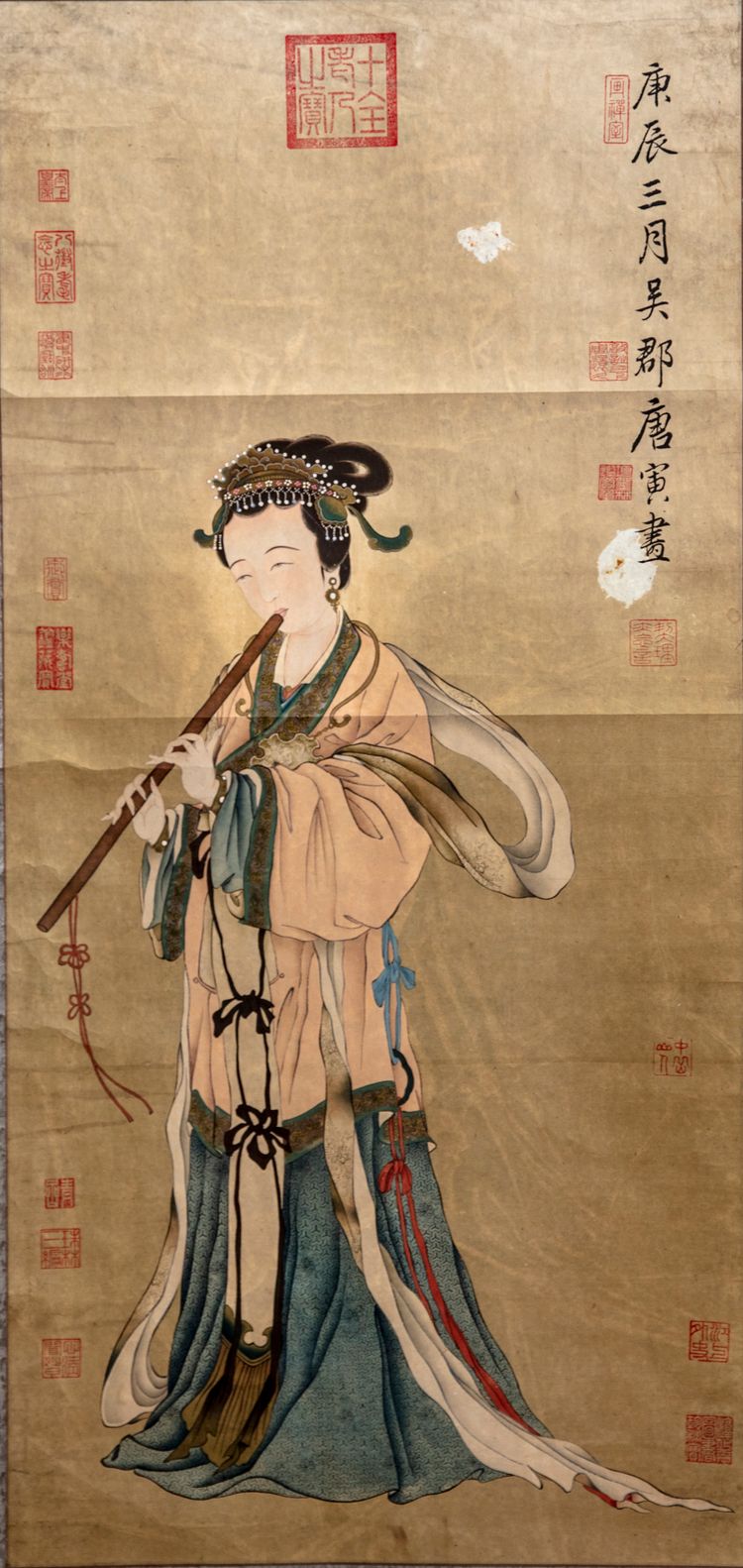 A Chinese hand scroll depicting a lady playing the flute