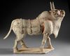 A VERY RARE LARGE OF A WALKING OX IN FULL HARNESS, CHINA, SIX DYNASTIES (220-582 AD)