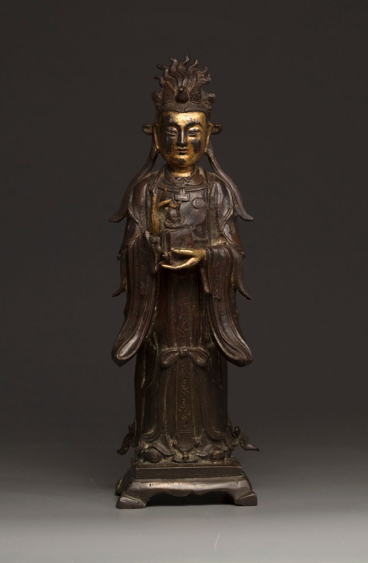 A Chinese parcel-gilt bronze figure of Xiwangmu