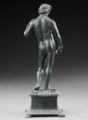 A ROMAN BRONZE STATUETTE OF APOLLO CARNEUS, CIRCA 1ST-2ND CENTURY A.D.