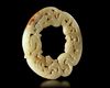 A WHITE JADE DRAGON/PHOENIX RING, HUAN, CHINA, HAN DYNASTY (206 BC-220 AD)