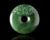A CHINESE SPINACH JADE CARVED DISC PENDANT, 20TH CENTURY