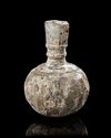 A WHEEL-WHEEL-CUT CLEAR GLASS BOTTLE NORTH EAST PERSIA, 9TH-10TH CENTURY