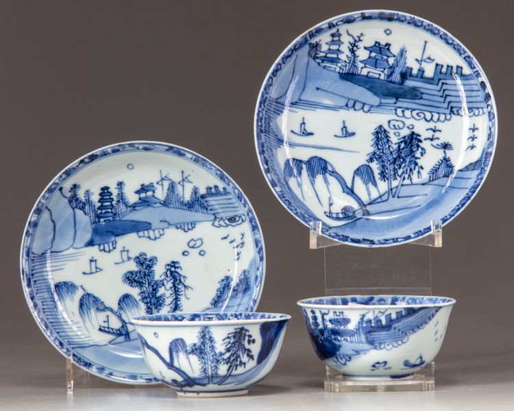 two cups and saucers decorated with multi-levels pavilions in a landscape