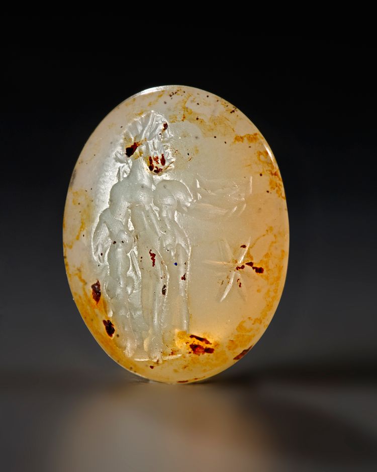 A ROMAN CHALCEDONY INTAGLIO OF STANDING HERCULES, CIRCA 2ND-3RD CENTURY A.D.