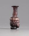 A ROMAN GLASS HEAD FLASK, CIRCA 3RD CENTURY AD