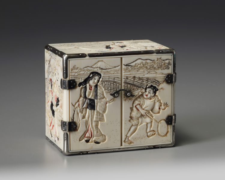 A small ivory and silver kodansu