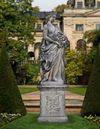 A SCULPTED LIMESTONE GROUP OF A MAIDEN AND CHERUB, SECOND HALF 20TH CENTURY