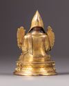 A parcel-gilt bronze figure of a Lama