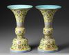 A PAIR OF CHINESE YELLOW-GROUND FAMILLE ROSE GU VASES, QING DYNASTY (1644-1911)