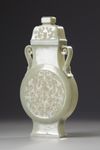 A Chinese celadon jade flattened vase and cover