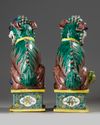 A LARGE PAIR OF CHINESE GLAZED-BISCUIT FAMILLE-VERTE FIGURES OF BUDDHIST LIONS, QING DYNASTY, 19TH CENTURY