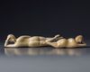 Two Chinese carved ivory reclining figures
