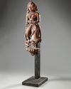 An Indian wood sculpture of a lady on a marble stand