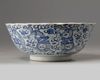 A Chinese blue and white foliate-rimmed 'nine dragon' bowl