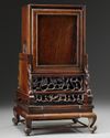 A Chinese gilt bronze table clock in a hongmu case and stand