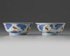 A pair of Chinese iron-red and gilt decorated blue and white bowls and cover