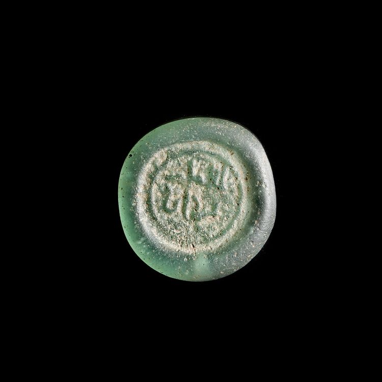 A FATIMID GLASS WEIGHT OF DIRHAM, EGYPT AL-AZIZ BILLAH ( 364-386 AH/ 975-996 AD)