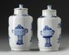 A pair of small Chinese blue and white vases and covers
