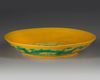 A CHINESE YELLOW-GROUND GREEN-ENAMELLED 'DRAGON' SAUCER,QING DYNASTY (1644–1911)