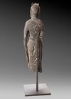 A FINELY CARVED STONE FIGURE OF A STANDING BUDDHIST DEITY