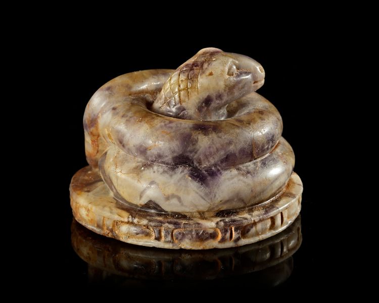 A ROMAN AMETHYST FIGURE OF A COILED SNAKE, 2ND-3RD CENTURY AD
