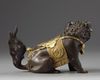 A Chinese parcel-gilt bronze Buddhist lion