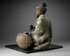 A JAPANESE SEATED LEGENDARY FIGURE WITH HAY BALE, 18TH CENTURY