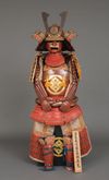 A RED LACQUER JAPANESE SUIT-OF-ARMOUR BY SATSUMA KUNIZUMI, 11TH GENERATION MITSUNOBU, MID 20TH CENTURY