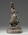 A CHINESE BRONZE FIGURE OF JAMBHALA ON A BUDDHIST LION, CHINA, 19TH-20TH CENTURY