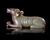 A CHINESE JADE OF A RECLINING DOG, HAN DYNASTY (206 BC–220 AD)