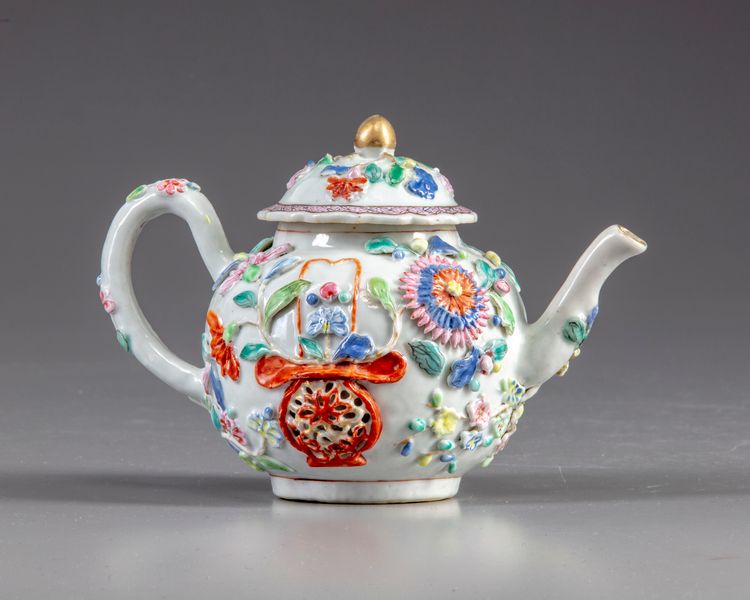 A Chinese famille rose moulded teapot and cover