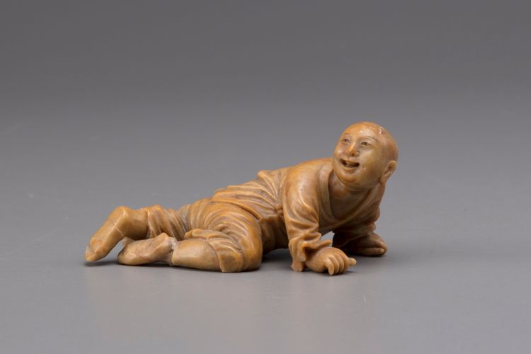 A soapstone figure of a young boy