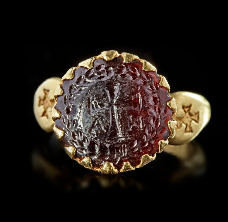 A BYZANTINE GOLD RING SET WITH A GARNET INTAGLIO, 6TH CENTURY AD OR LATER