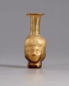 A ROMAN HEAD GLASS FLASK , CIRCA 3RD CENTURY AD
