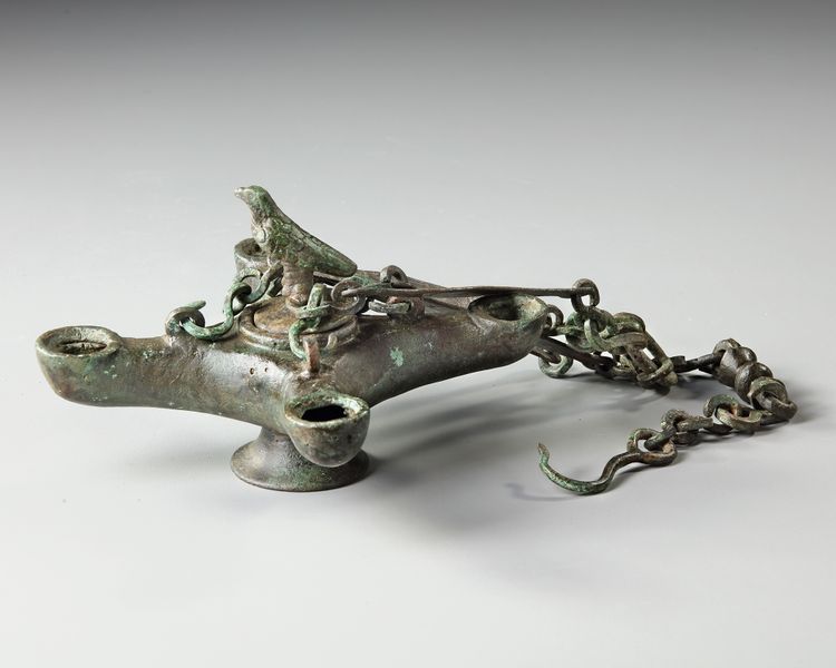 A BYZANTINE FOUR SPOUTED LAMP, 6TH-7TH CENTURY AD