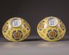 A pair of Chinese yellow-ground famille rose bowls