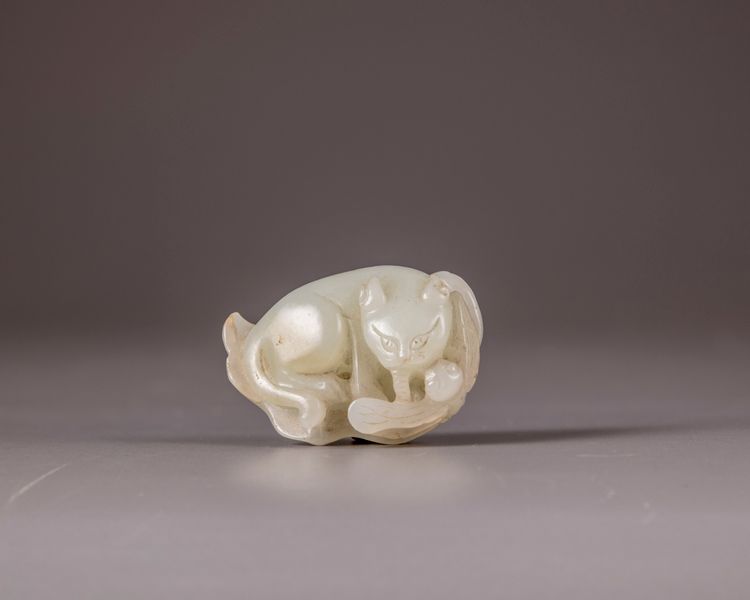 A Chinese pale celadon jade 'cat and dragonfly' carving