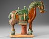 A CHINESE GREEN AND BROWN  GLAZED HORSE, MING DYNASTY (1368-1644 AD)