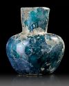 A MOULDED BLUE GLASS BOTTLE, NISHAPUR, NORTH-EAST PERSIA, 9TH CENTURY