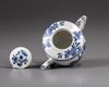 A small Chinese blue and white teapot and cover