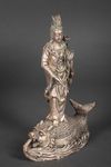 A METAL SCULPTURE OF GUANYIN STANDING ON A FISH, 20TH CENTURY