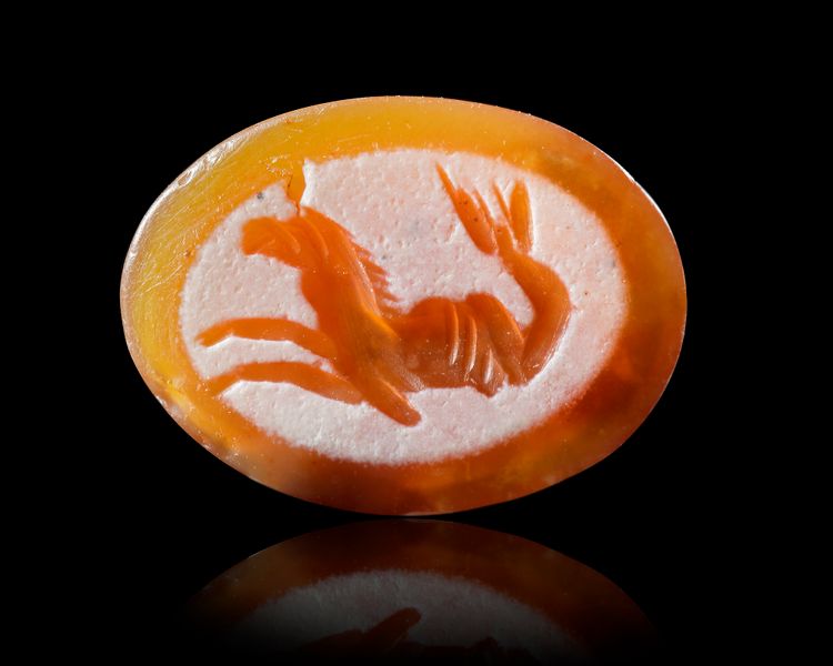 A ROMAN CARNELIAN INTAGLIO WITH SEA MONSTER, 1ST-2ND CENTURY AD