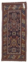 AN ANTIQUE CAUCASIAN RUG RUNNER
