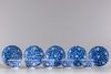 Five blue and white cups and seven saucers