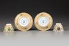 A PAIR OF CAFE AU-LAIT GROUND FAMILLE VERTE CUPS AND SAUCERS, KANGXI PERIOD (1662-1722)