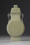 A Chinese celadon jade flattened vase and cover